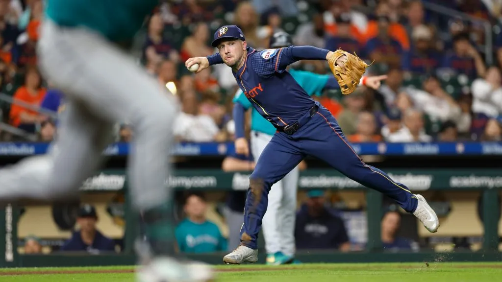 Alex Bregman #2 of the Houston Astros fields a bunt that went for a hit in the eighth inning against the Seattle Mariners at Minute Maid Park on September 23, 2024 in Houston, Texas. (Photo by Tim Warner/Getty Images)