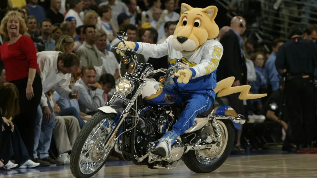 The Denver Nuggets mascot, Rocky the Mountain Lion, rides a motorcycle during an intermission in Game four against the Minnesota Timberwolves during the 2004 NBA Playoffs. (Source: Brian Bahr/Getty Images)