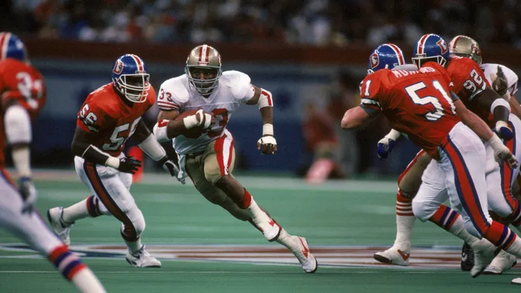 Running back Roger Craig #33 of the San Francisco 49ers looks for room to run against Denver Broncos inside linebacker Marc Munford #54 in the second quarter of Super Bowl XXIV.