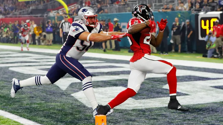 Tevin Coleman #26 of the Atlanta Falcons carries the ball past Rob Ninkovich #50 of the New England Patriots for a six yard touchdown during Super Bowl 51 in 2017.
