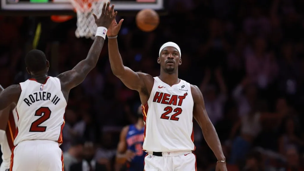 Jimmy Butler high fives Terry Rozier of the Miami Heat during a game against the Detroit Pistons at Kaseya Center on October 28, 2024.