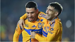 Juan Vigon of Tigres celebrates with teammate