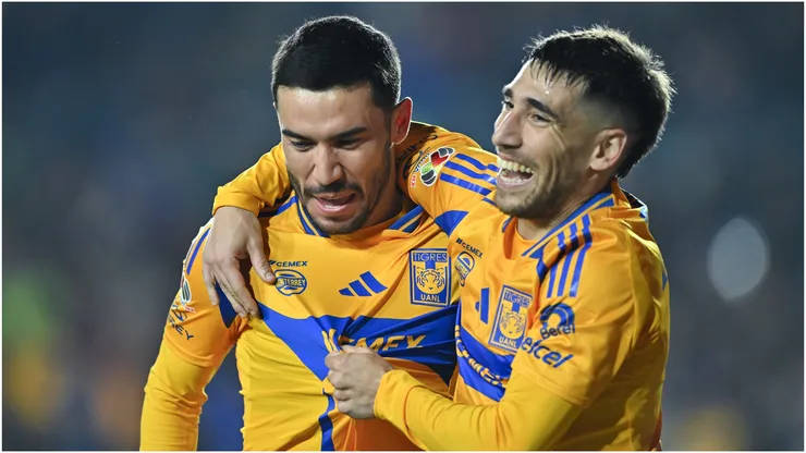 Juan Vigon of Tigres celebrates with teammate