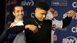 David Stearns, the president of baseball operations for the New York Mets fits Juan Soto with his New York Mets jersey during his introductory press conference at Citi Field on December 12, 2024 in New York City.