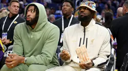 Anthony Davis #3 and LeBron James #23 of the Los Angeles Lakers sit on the bench during their preseason game against the Golden State Warriors at Chase Center on October 18, 2024 in San Francisco, California.