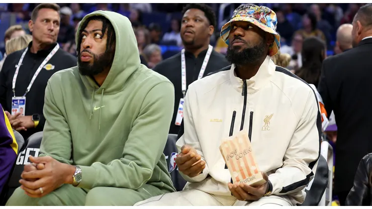 Anthony Davis #3 and LeBron James #23 of the Los Angeles Lakers sit on the bench during their preseason game against the Golden State Warriors at Chase Center on October 18, 2024 in San Francisco, California.