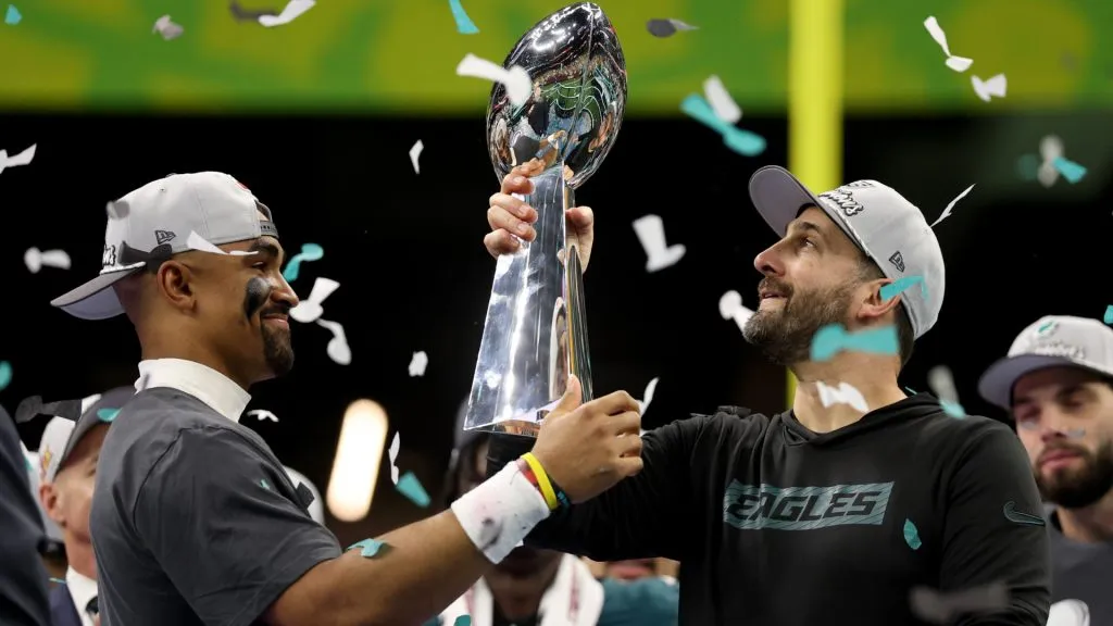 Jalen Hurts #1 of the Philadelphia Eagles hands the Vince Lombardi Trophy to head coach Nick Sirianni after beating the Kansas City Chiefs 40-22 to win Super Bowl LIX. (Source: Jamie Squire/Getty Images)