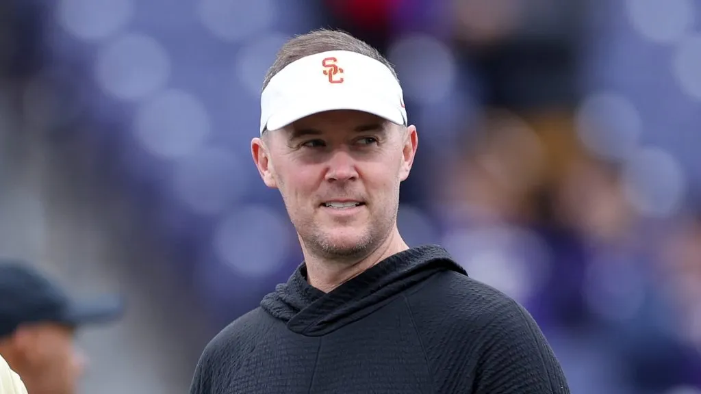 Head coach Jedd Fisch of the Washington Huskies and head coach Lincoln Riley of the USC Trojans talk before the game at Husky Stadium on November 02, 2024 in Seattle, Washington.