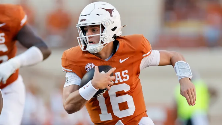 Arch Manning #16 of the Texas Longhorns scrambles in the second half while defended by Deonte Anderson #91 of the Mississippi State Bulldogs at Darrell K Royal-Texas Memorial Stadium on September 28, 2024 in Austin, Texas.
