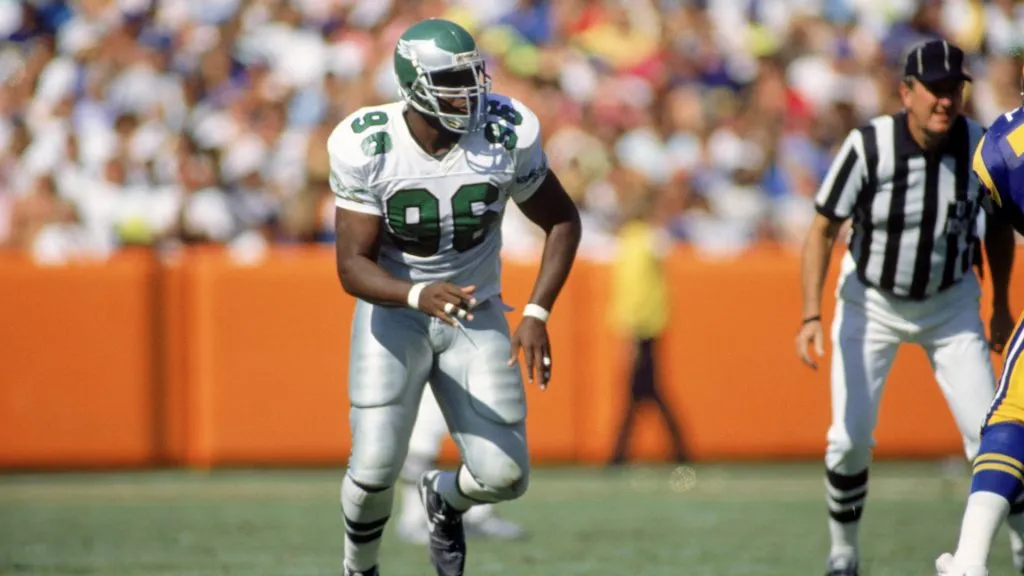 Defensive end Clyde Simmons #96 of the Philadelphia Eagles rushes in to make a tackle against the Los Angeles Rams at Anaheim Stadium on September 23, 1990. (Source: Stephen Dunn/Getty Images)