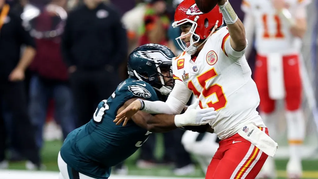 Patrick Mahomes of the Kansas City Chiefs runs with the ball while being chased by Brandon Graham of the Philadelphia Eagles