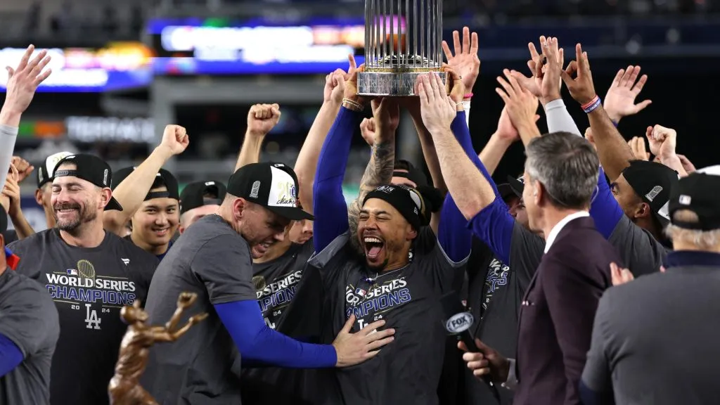 Mookie Betts #50 of the Los Angeles Dodgers celebrates with the trophy after the Dodgers defeated the New York Yankees 7-6 in game 5 to win the 2024 World Series at Yankee Stadium on October 30, 2024 in the Bronx borough of New York City. (Photo by Elsa/Getty Images)