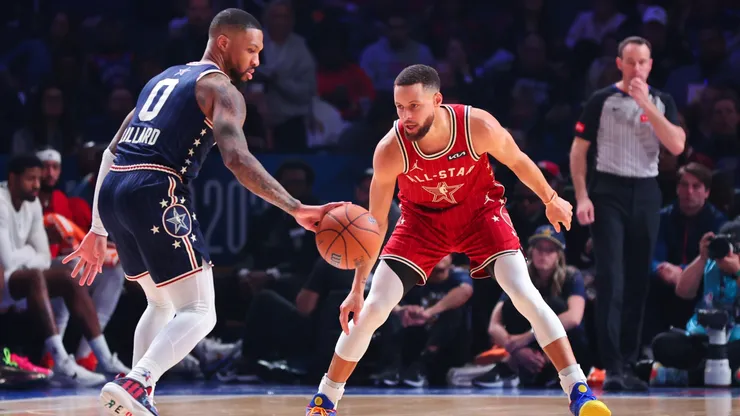 Damian Lillard #0 of the Milwaukee Bucks dribbles the ball against Stephen Curry #30 of the Golden State Warriors in the third quarter during the 2024 NBA All-Star Game.