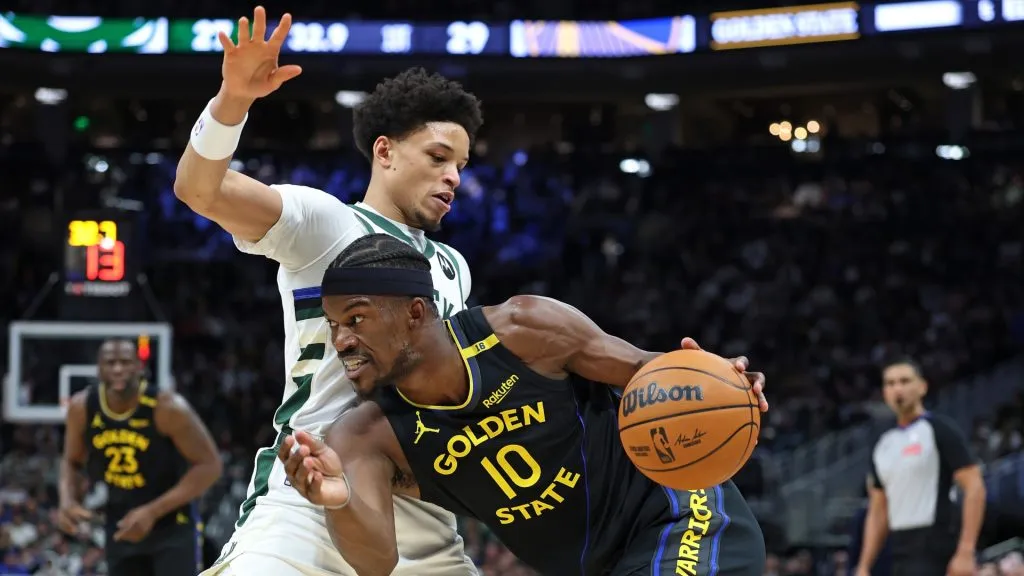 Jimmy Butler #10 of the Golden State Warriors drives around Ryan Rollins #13 of the Milwaukee Bucks during a game at Fiserv Forum on February 10, 2025 in Milwaukee, Wisconsin. (Photo by Stacy Revere/Getty Images)