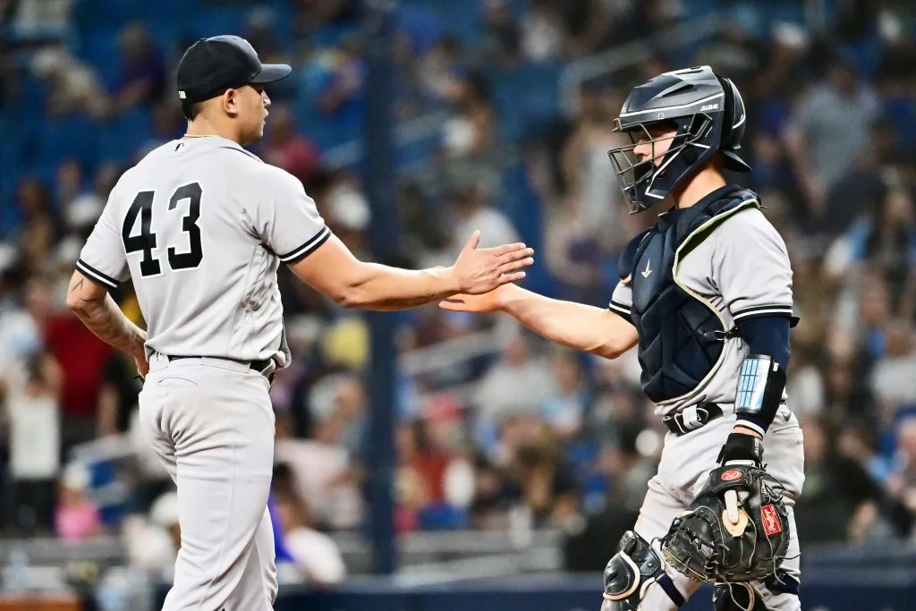 Jonathan Loaisiga (L) #43 celebrates with Ben Rortvedt #38 of the New York Yankees 
