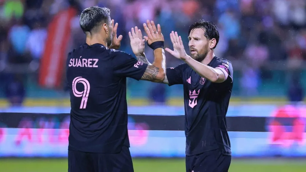 Lionel Messi of Inter Miami celebrates with teammate Luis Suarez after scoring the team’s first goal during a friendly match between Olimpia and Inter Miami. (Manuel Velasquez/Getty Images)