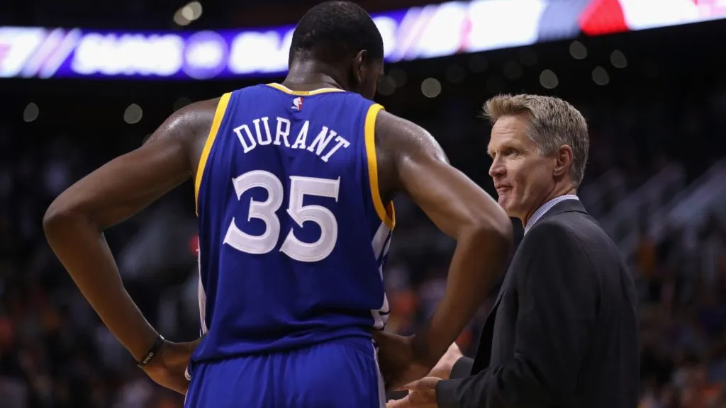 Golden State Warriors coach Steve Kerr talks with Kevin Durant during a game against the Phoenix Suns on October 30, 2016.
