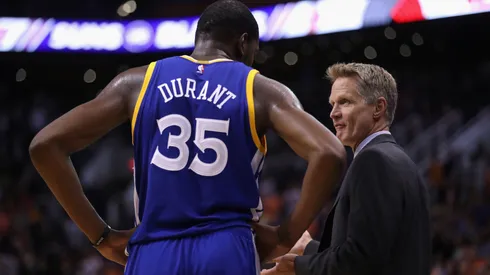 Golden State Warriors coach Steve Kerr talks with Kevin Durant during a game against the Phoenix Suns on October 30, 2016.
