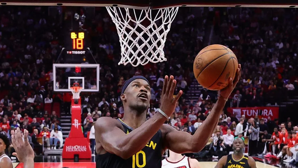 Jimmy Butler #10 of the Golden State Warriors shoots the ball against Aaron Holiday #0 of the Houston Rockets
