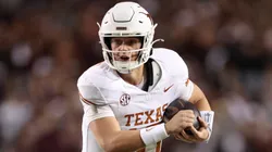 Arch Manning #16 of the Texas Longhorns scrambles in the first half against the Texas A&M Aggies at Kyle Field on November 30, 2024 in College Station, Texas.
