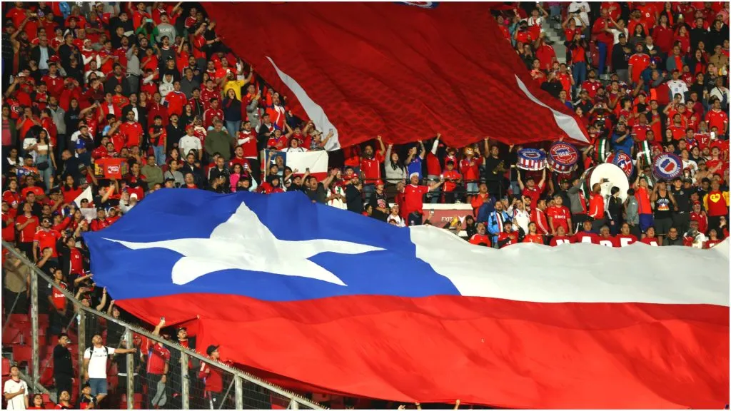 Fans of Chile cheer with flags – Marcelo Hernandez/Getty Images