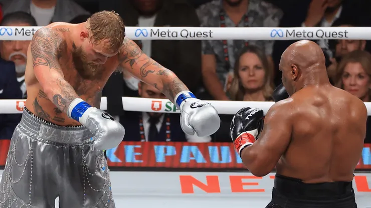 Jake Paul honors Mike Tyson after his unanimous-decision win during a heavyweight bout.