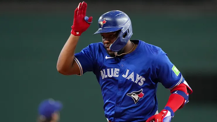 Vladimir Guerrero Jr. #27 of the Toronto Blue Jays celebrates toward his dugout after hitting a solo home run during the ninth inning against the Texas Rangers at Globe Life Field on September 19, 2024 in Arlington, Texas.