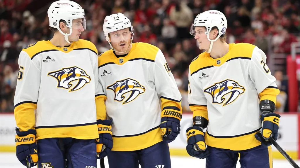 Brady Skjei #76, Gustav Nyquist #14 and Joakim Kemell #25 of the Nashville Predators confer against the Chicago Blackhawks during the third period on February 07, 2025. (Source: Michael Reaves/Getty Images)
