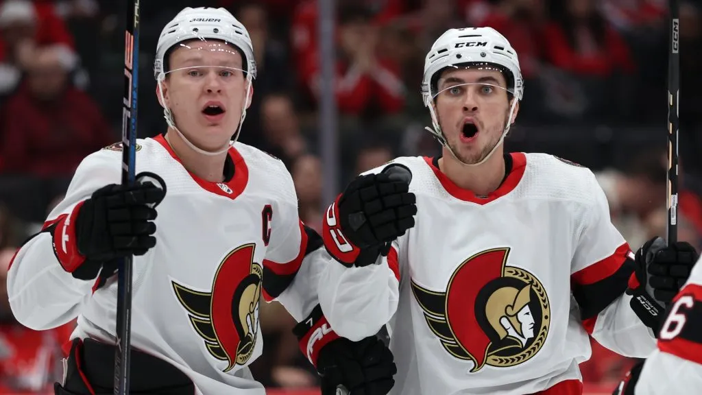 Shane Pinto #57 of the Ottawa Senators (R) reacts after scoring a goal against the Washington Capitals during the first period at Capital One Arena on February 26, 2024. (Source: Patrick Smith/Getty Images)