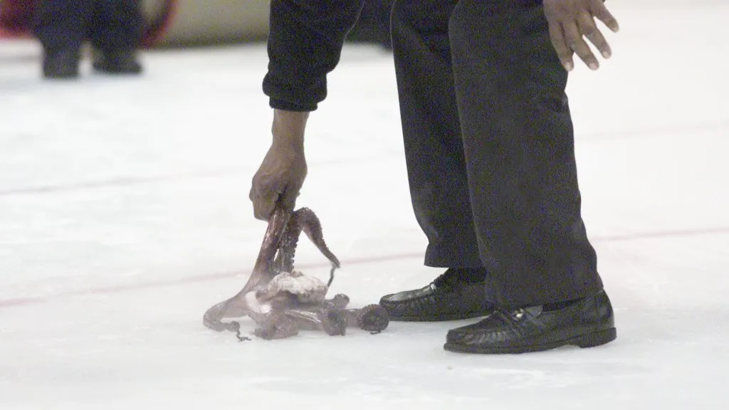 Maintenance removes an octopus thrown on the ice in celebration after the Detroit Red Wings scored a goal over the Vancouver Canucks during game 2 of the Stanley Cup playoffs in 2002. (Source: Tom Pidgeon/Getty Images/NHLI)