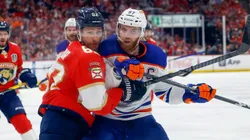 Brandon Montour #62 of the Florida Panthers and Connor McDavid #97 of the Edmonton Oilers battle during first period action in Game Seven of the Final of the 2024 Stanley Cup Playoffs.