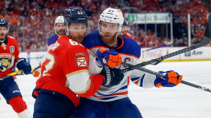 Brandon Montour #62 of the Florida Panthers and Connor McDavid #97 of the Edmonton Oilers battle during first period action in Game Seven of the Final of the 2024 Stanley Cup Playoffs.