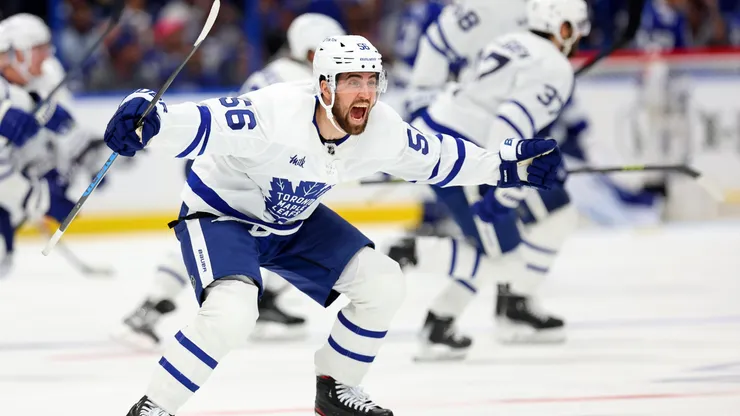 Erik Gustafsson #56 of the Toronto Maple Leafs celebrate winning Game Six of the First Round of the 2023 Stanley Cup Playoffs on an overtime goal by John Tavares #91 against the Tampa Bay Lightning.