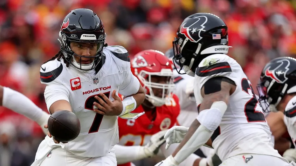 C.J. Stroud #7 of the Houston Texans hands off to Joe Mixon #28 against the Kansas City Chiefs during the second quarter in the AFC Divisional Playoff at GEHA Field at Arrowhead Stadium on January 18, 2025 in Kansas City, Missouri.