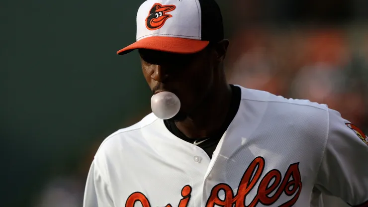 Centerfielder Adam Jones #10 of the Baltimore Orioles blows a bubble with his gum as he warms up before the start of a game against the Cleveland Indians in 2013.