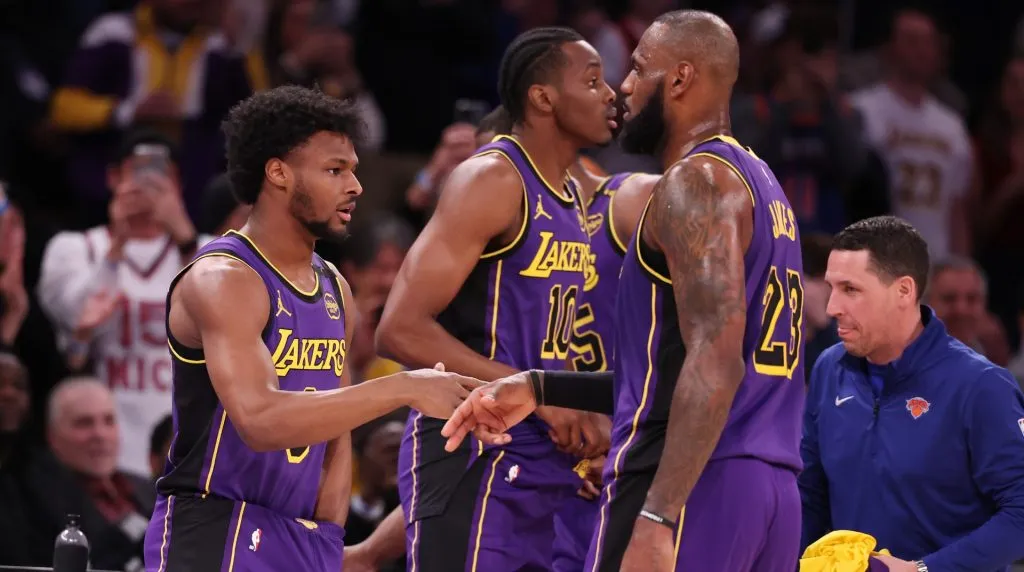 Bronny James #9 of the Los Angeles Lakers shakes hands with LeBron James #23 of the Los Angeles Lakers before entering the game in the fourth quarter against the New York Knicks during their game at Madison Square Garden on February 01, 2025 in New York City. (Photo by Al Bello/Getty Images)