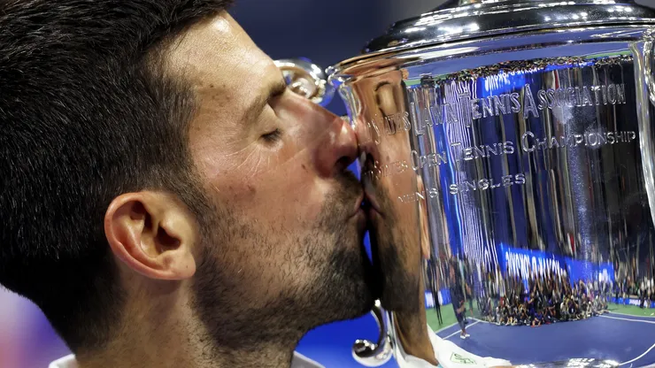 Novak Djokovic of Serbia kisses his winners trophy after defeating Daniil Medvedev of Russia during their Men's Singles Final match on Day Fourteen of the 2023 US Open.