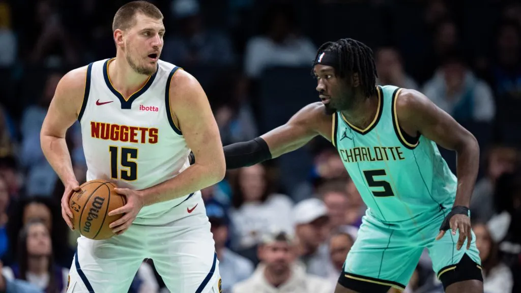 Mark Williams #5 of the Charlotte Hornets guards Nikola Jokic #15 of the Denver Nuggets in the first quarter during their game at Spectrum Center. (Jacob Kupferman/Getty Images)