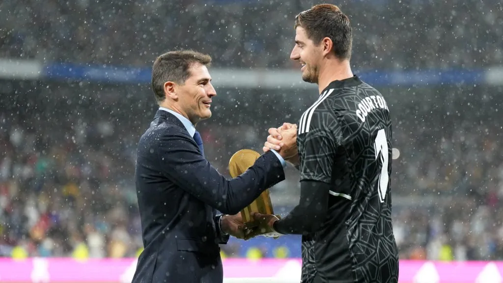 Thibaut Courtois is presented with the Yashin Trophy by Iker Casillas prior to a match between Real Madrid CF and Sevilla FC. (Angel Martinez/Getty Images)