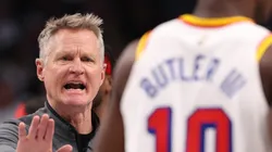 Head coach Steve Kerr of the Golden State Warriors talks to Jimmy Butler #10 during the third quarter against the Dallas Mavericks