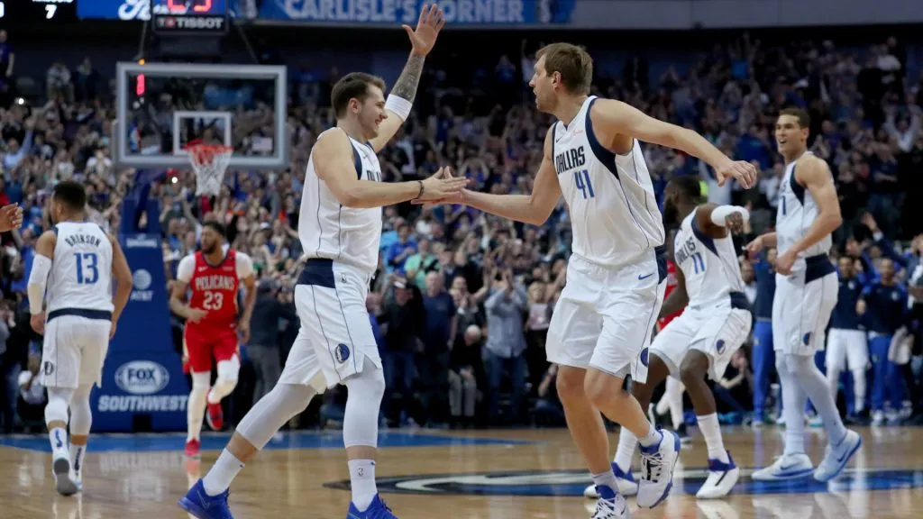 Dirk Nowitzki #41 of the Dallas Mavericks celebrates with Luka Doncic #77 of the Dallas Mavericks after scoring a basket against the New Orleans Pelicans. (Tom Pennington/Getty Images)