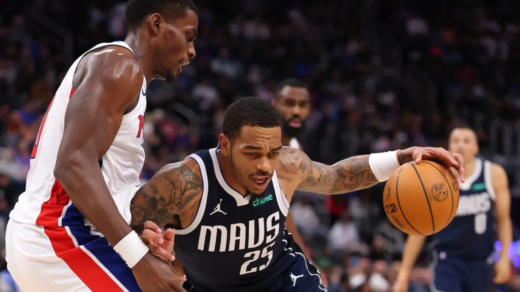 Washington #25 of the Dallas Mavericks tries to drive around Jalen Duren #0 of the Detroit Pistons during the first half at Little Caesars Arena. (Gregory Shamus/Getty Images)