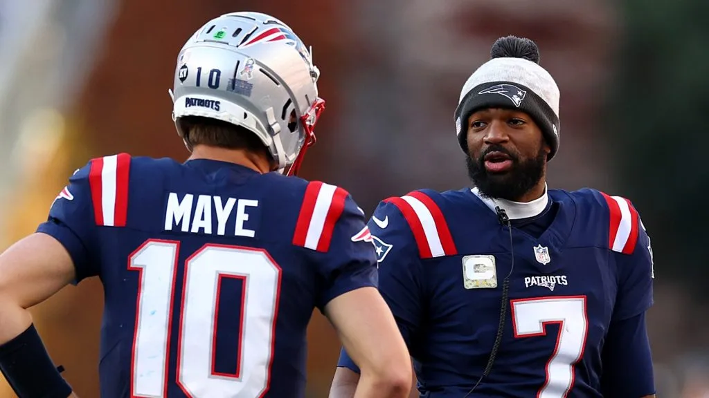 Jacoby Brissett #7 and Drake Maye #10 of the New England Patriots talk during the game against the Los Angeles Rams at Gillette Stadium on November 17, 2024 in Foxborough, Massachusetts.