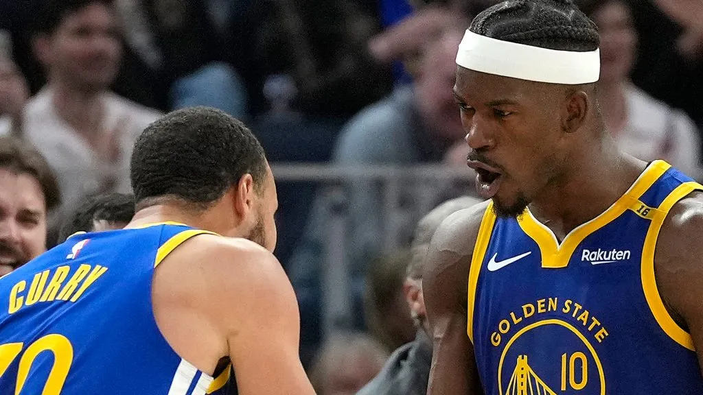 Jimmy Butler III #10 and Stephen Curry #30 of the Golden State Warriors celebrate after Butler scored and was fouled on the shot against the Dallas Mavericks