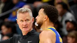 Head Coach Steve Kerr of the Golden State Warriors speaks with Stephen Curry #30 against the Denver Nuggets