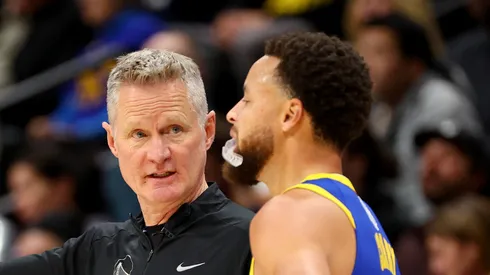 Head Coach Steve Kerr of the Golden State Warriors speaks with Stephen Curry #30 against the Denver Nuggets