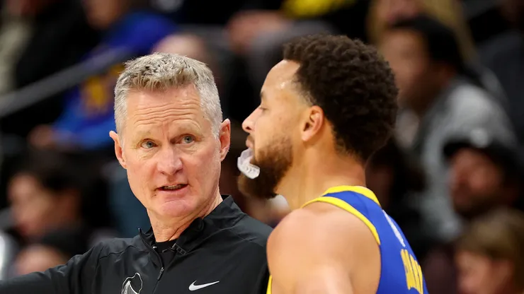 Head Coach Steve Kerr of the Golden State Warriors speaks with Stephen Curry #30 against the Denver Nuggets
