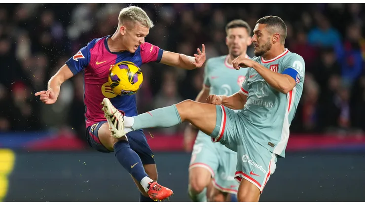 Dani Olmo of FC Barcelona is challenged by Koke of Atletico de Madrid during the LaLiga match between FC Barcelona and Atletico de Madrid at Estadi Olimpic Lluis Companys on December 21, 2024 in Barcelona, Spain.
