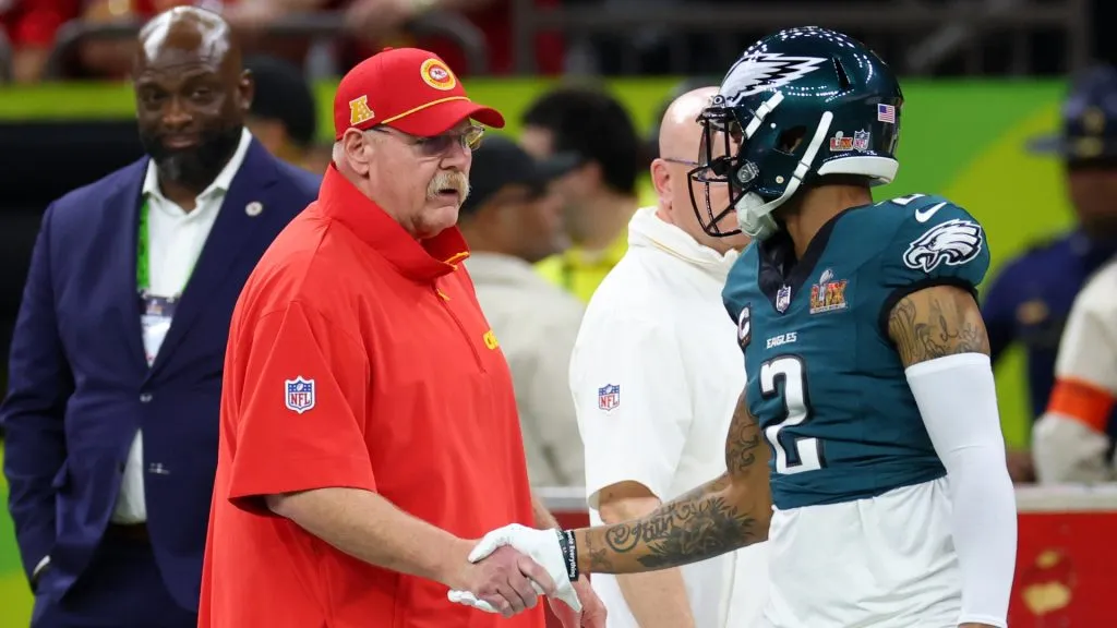 Head coach Andy Reid of the Kansas City Chiefs meets with Darius Slay Jr. #2 of the Philadelphia Eagles before Super Bowl LIX at Caesars Superdome on February 09, 2025 in New Orleans, Louisiana.