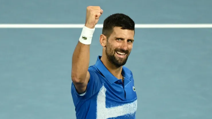 Novak Djokovic of Serbia celebrates winning a match point against Carlos Alcaraz of Spain in the quarterfinal of the 2025 Australian Open.